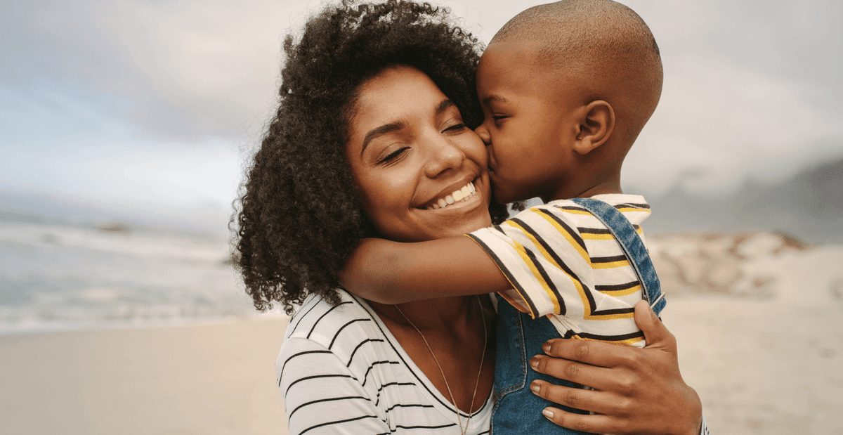 mother-child-kiss-beach