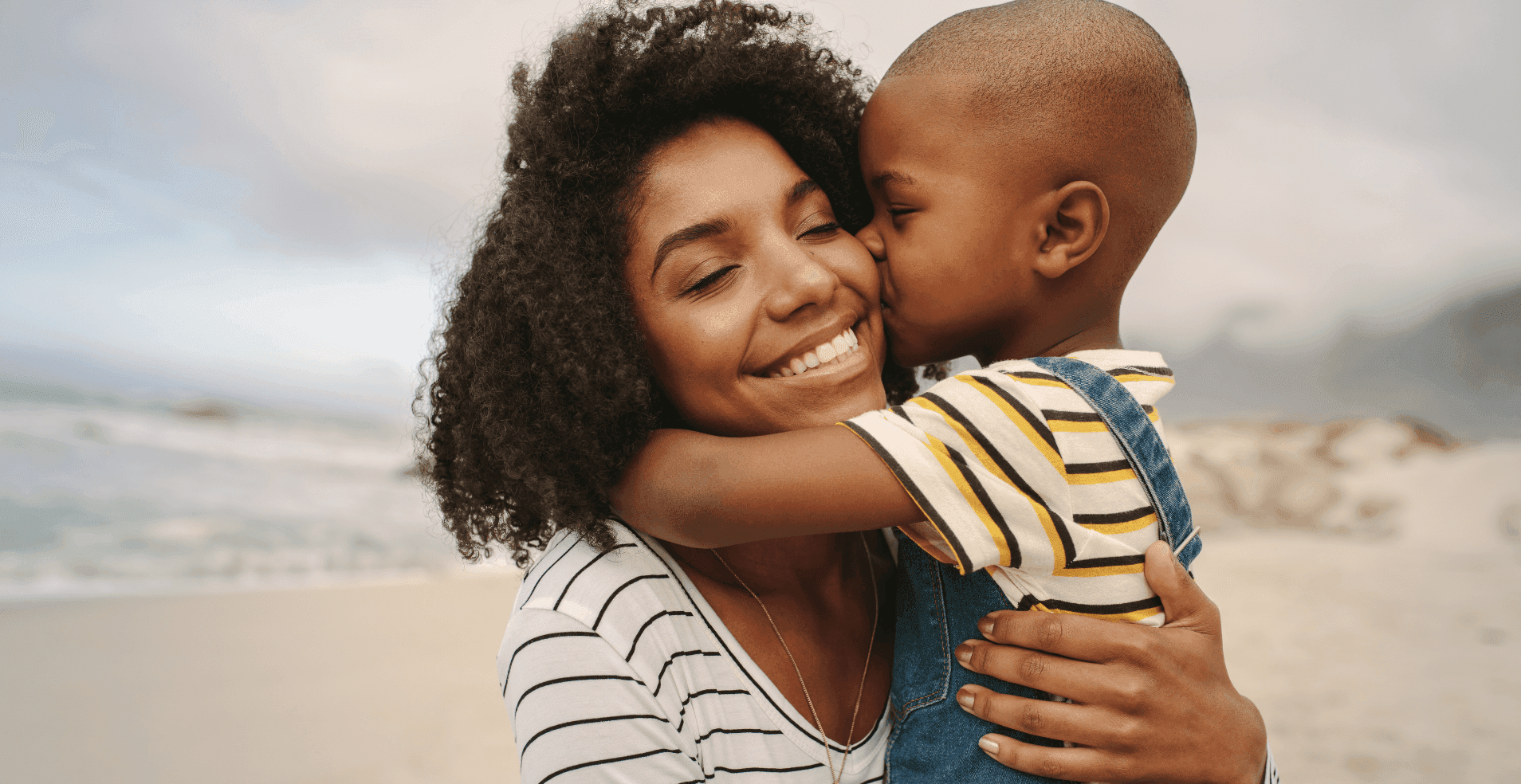 mother-child-kiss-beach